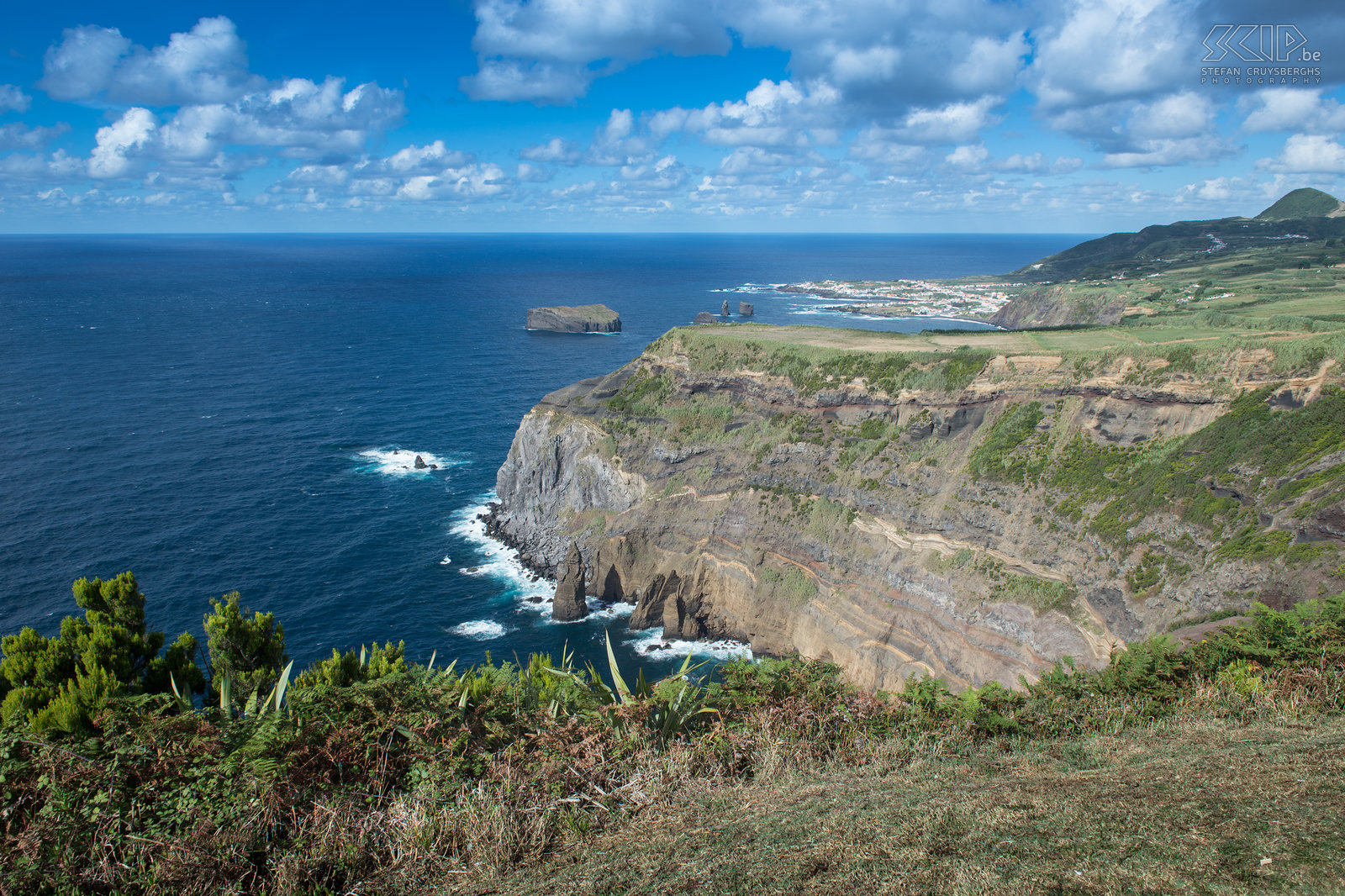 Cliffs of west coast Cliffs of west coast of São Miguel with in the background the village of Mosteiros. Stefan Cruysberghs